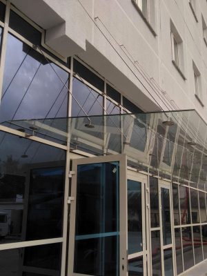 Glass canopy on glass facade